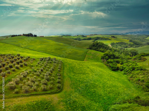 Amazing colorful sunset in Tuscany. Picturesque agrotourism and typical curved road with cypress, landscape in Tuscany, Italy, Europe