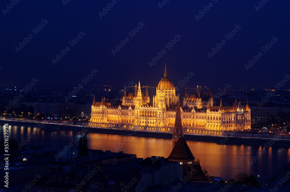 Budapest parliament building at night, long exposure. Hungarian Parliament building and Danube River in the Budapest city at night. Neo-gothic architecture, Budapest's tourist attraction