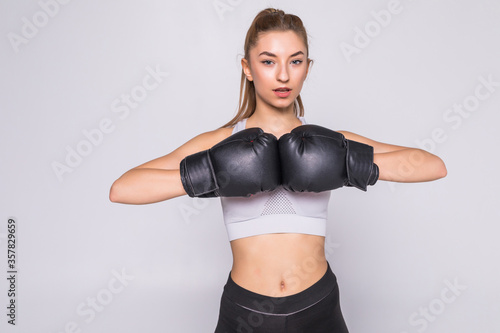Fit woman boxing isolated over a white background © dianagrytsku