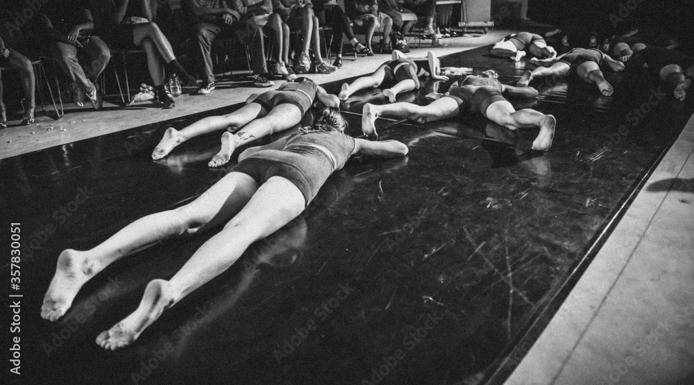 Girls crawl on the floor. Musical and theatrical performance. Black and white vintage style photo. - obrazy, fototapety, plakaty 
