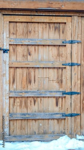 Vertical frame Close up of wooden cabinet with hinged door and sliding barrel bolt latch