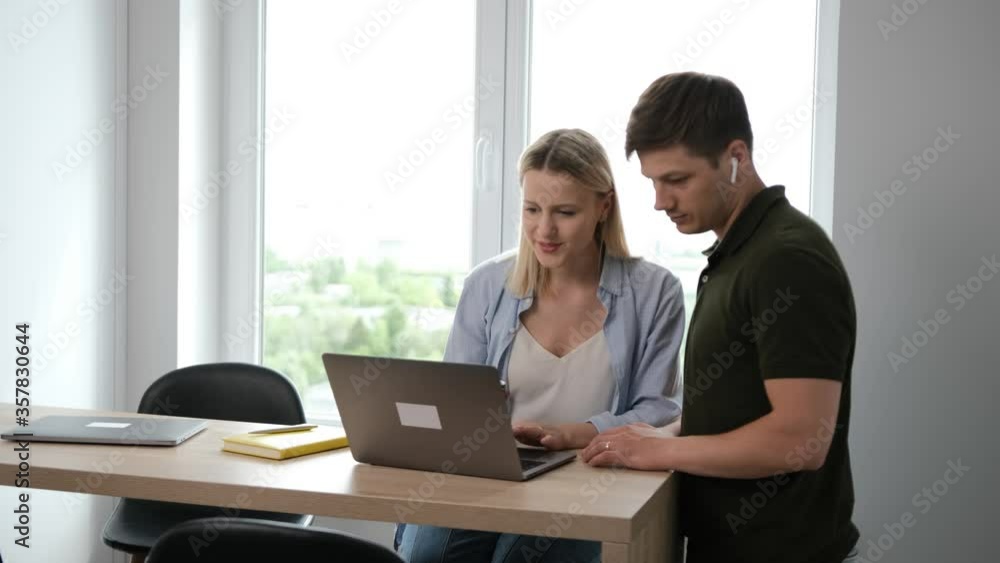 Caucasian young couple choose the items to buy online for their home. Spend time together Caucasian young couple choose the items to buy online for their home. Spend time together