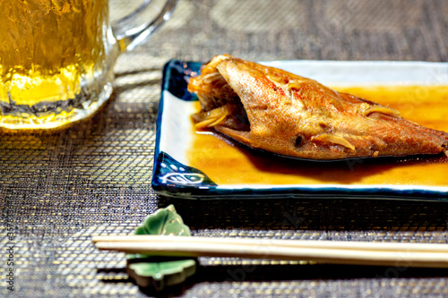 Boiled red fish served with beer at supper in Japan photo