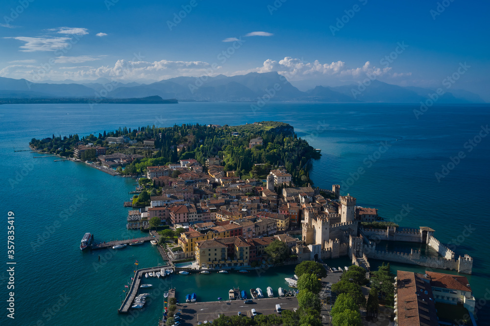 Castle Rocca Scaligera in Sirmione, Garda Lake. View by Drone. Panoramic aerial view of the historic city of Sirmione. Alps of Lake Garda