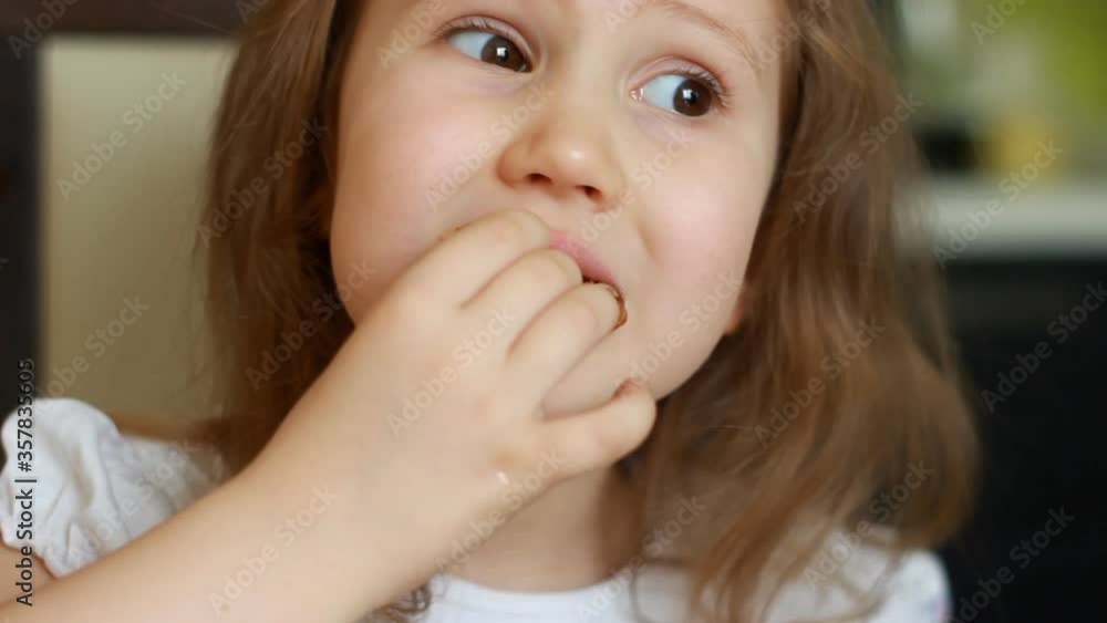 Baby girl eating pancakes for breakfast. Portrait child and food close up Baby girl eating pancakes for breakfast. Portrait child and food close up