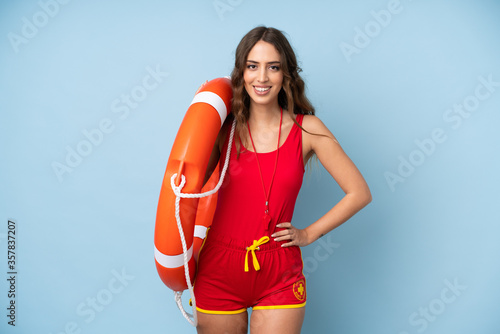 Young woman over isolated background with lifeguard equipment and with happy expression