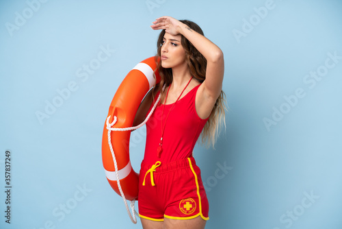 Young woman over isolated background with lifeguard equipment and showing something