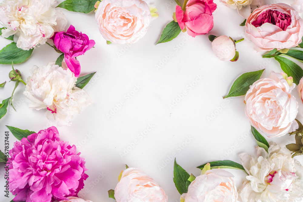 Flat lay of flowers and green leaves. Tender Peonies and chrysanthemums bloom pattern, composition for postcards on white background.