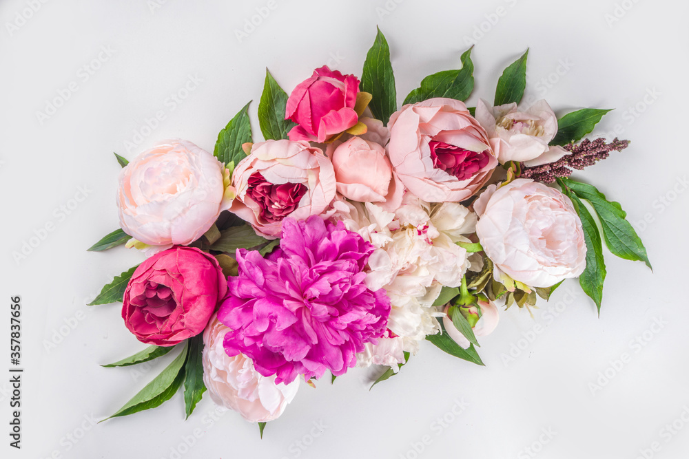 Flat lay of flowers and green leaves. Tender Peonies and chrysanthemums bloom pattern, composition for postcards on white background. Flat lay of flowers and green leaves. Tender Peonies and chrysanthemums bloom pattern, composition for postcards on white background.
