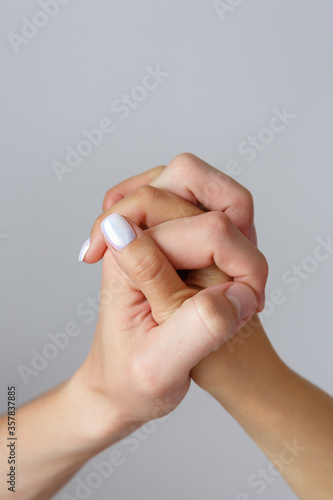 Male and female hands on a white background close-up. The concept of love  family and fidelity. Feelings and Attitudes