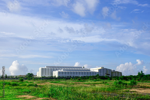 Industry factory buidling with modern warehouse in blue sky clouds background. Environmentally friendly manufacturing plant of new technology production line