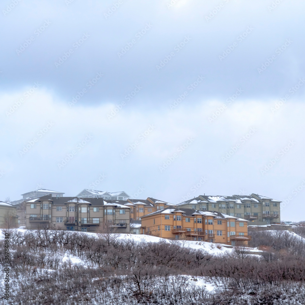 Square Hill with homes on its gentle slope covered with fresh snow during winter season