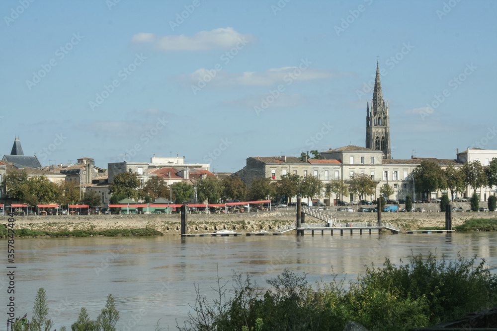 Panorama of Libourne seen from the Garonne river with a focus on the church of Eglise Saint Jean Baptiste. Libourne is a major town in Gironde, in the Aquitaine region