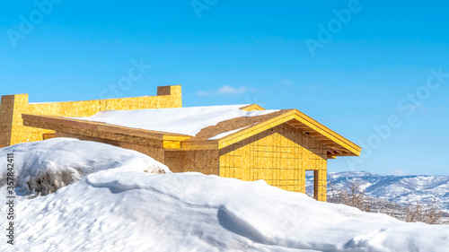 Panorama crop Home under construction on a mountain covered with snow in Park City Utah
