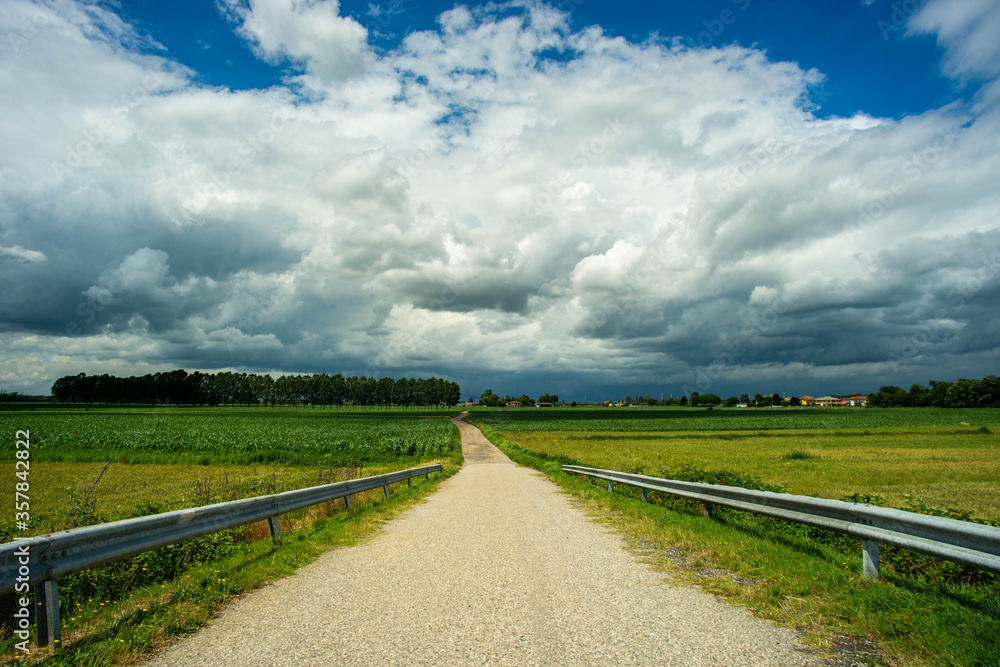 country dirt road that meets the storm