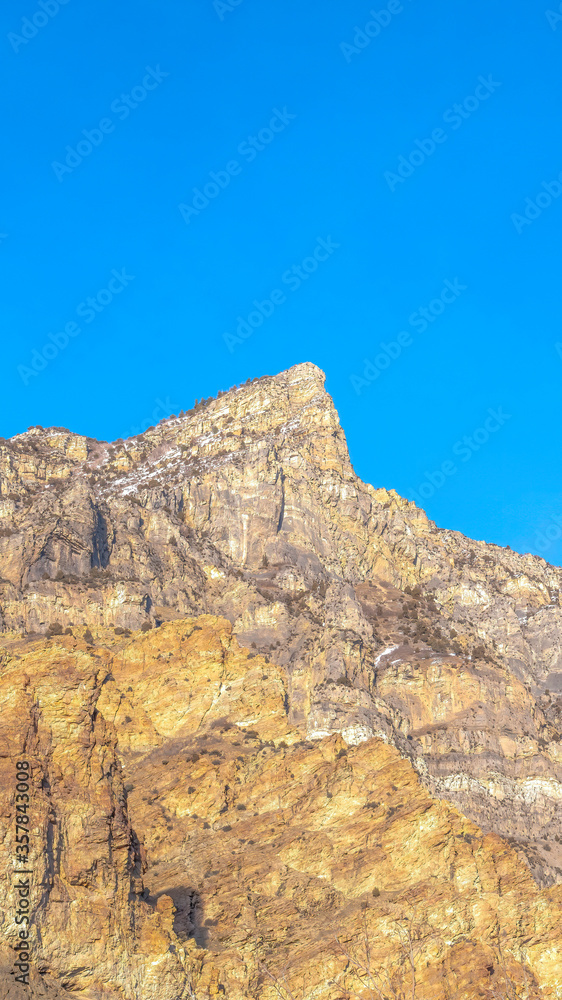 Vertical crop Steep peak and rocky slopes of a mountain in Provo Canyon Utah on a sunny day