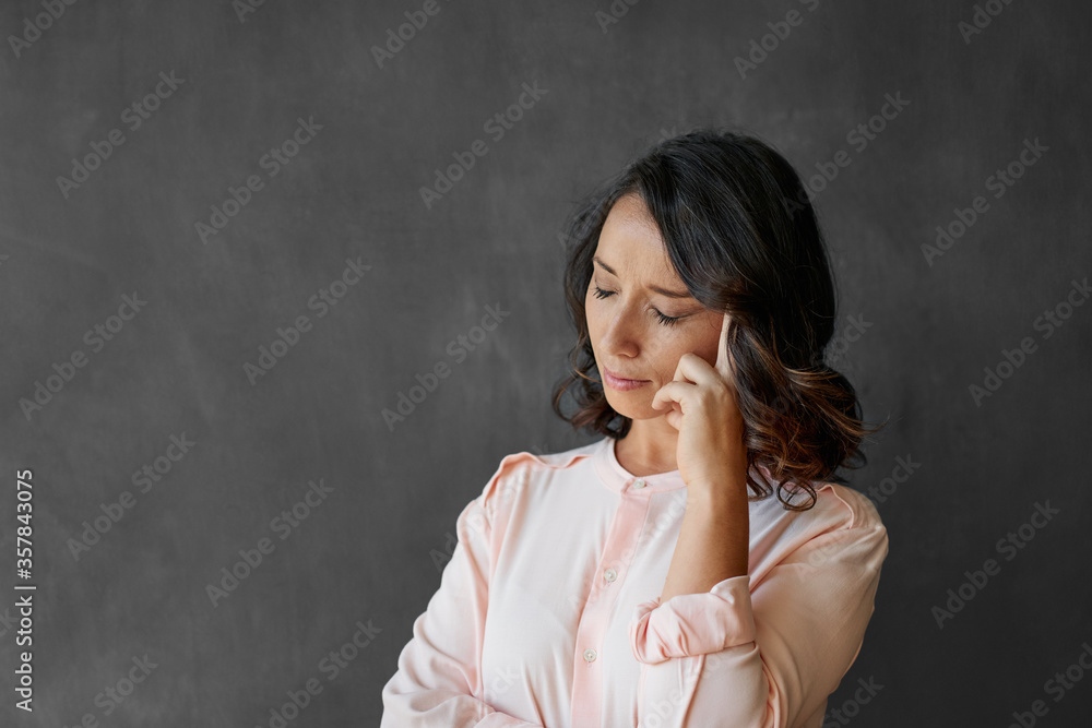 Young businesswoman looking stressed in front of a chalkboard Young businesswoman looking stressed in front of a chalkboard