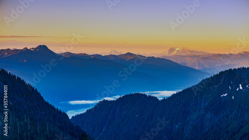 Alpine vista with clouds lake and mountains at sunrise © David