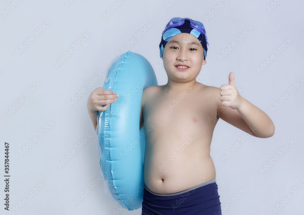 Asian boys in swimsuit on gray background Asian boys in swimsuit on gray background