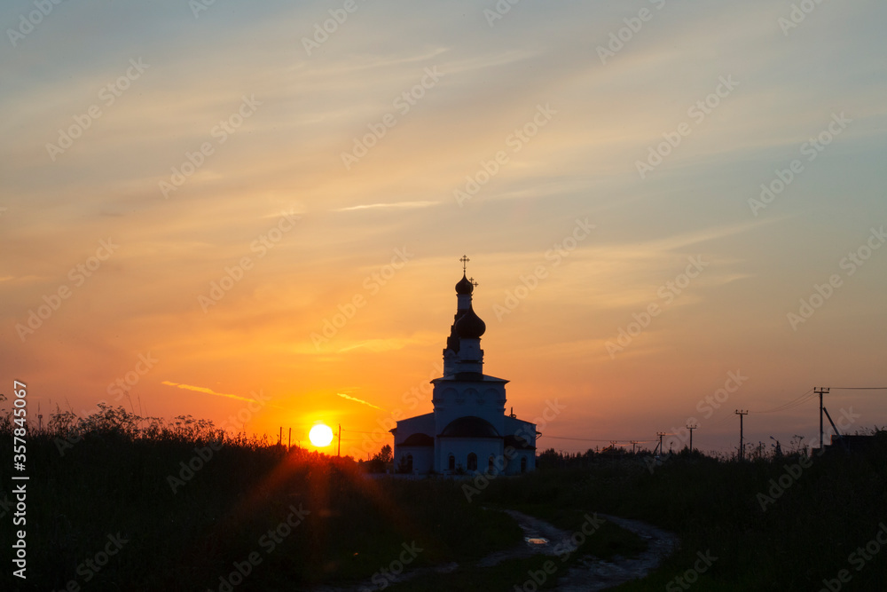 Beautiful evening view of the Orthodox Church in a field at sunset in Russia Moscow Region