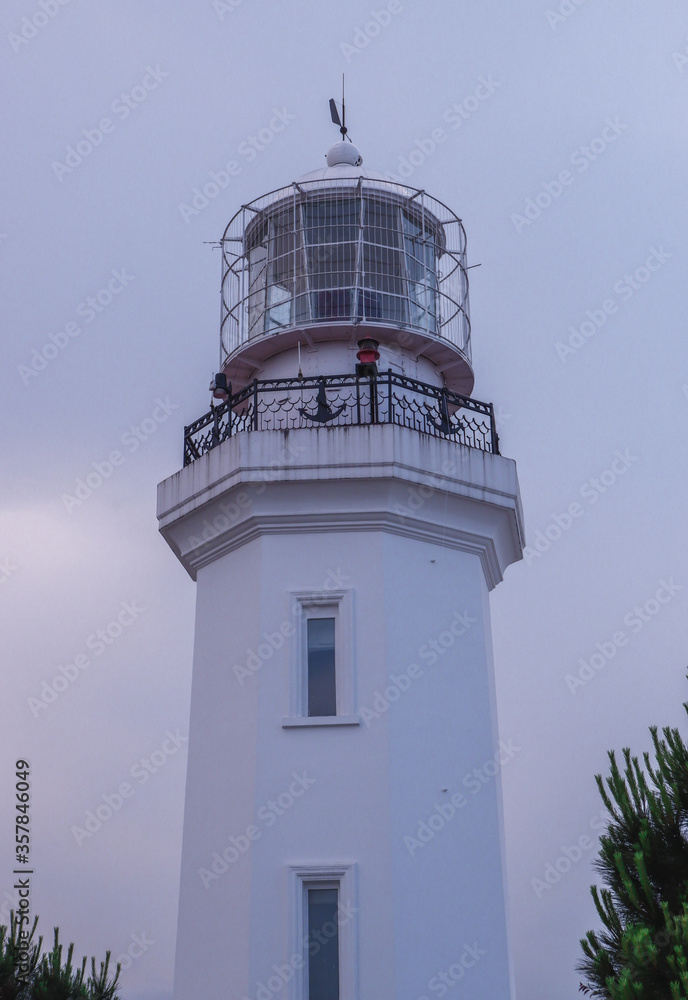 White lighthouse on The black sea coast. Lighthouse in Batumi, Georgia. A popular tourist destination. White lighthouse on The black sea coast. Lighthouse in Batumi, Georgia. A popular tourist destination.