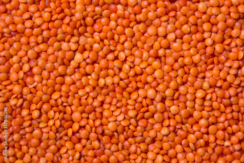 Background with red lentils. Lots of lentils. Raw ingredients for cooking. Healthy, clean eating concept.
