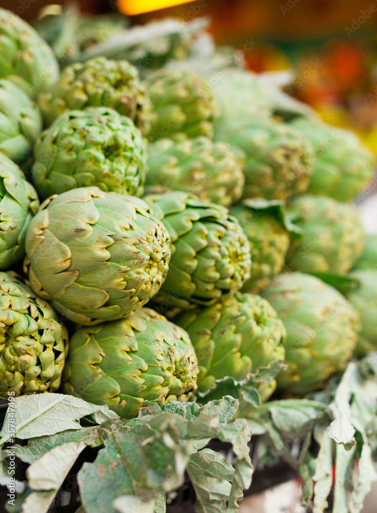 Fresh artichokes on market counter Fresh artichokes on market counter
