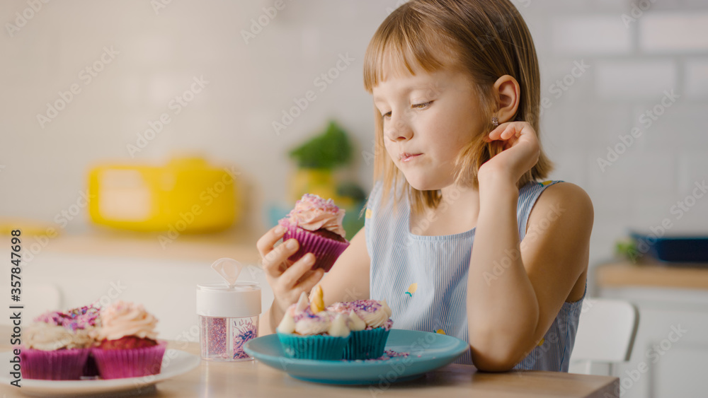 In the Kitchen: Adorable Little Girl Eats Creamy Cupcake with Frosting and Sprinkled Funfetti. Cute Hungry Sweet Tooth Child Bites into Muffin with Sugary Frosting In the Kitchen: Adorable Little Girl Eats Creamy Cupcake with Frosting and Sprinkled Funfetti. Cute Hungry Sweet Tooth Child Bites into Muffin with Sugary Frosting