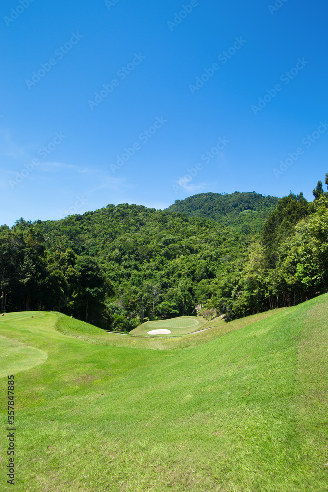View of golf course in the mountains behind the sky View of golf course in the mountains behind the sky