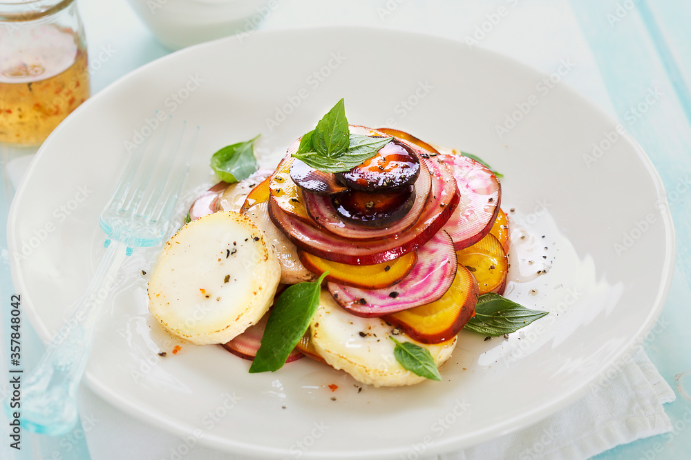 Colourful salad - beetroots slices with goat's cheese and vinaigrette 