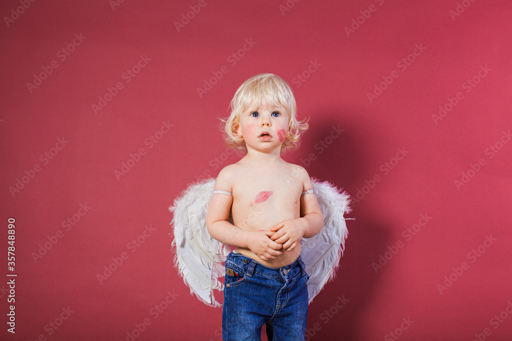 Cute boy with angel wings strares on something Cute boy with angel wings strares on something