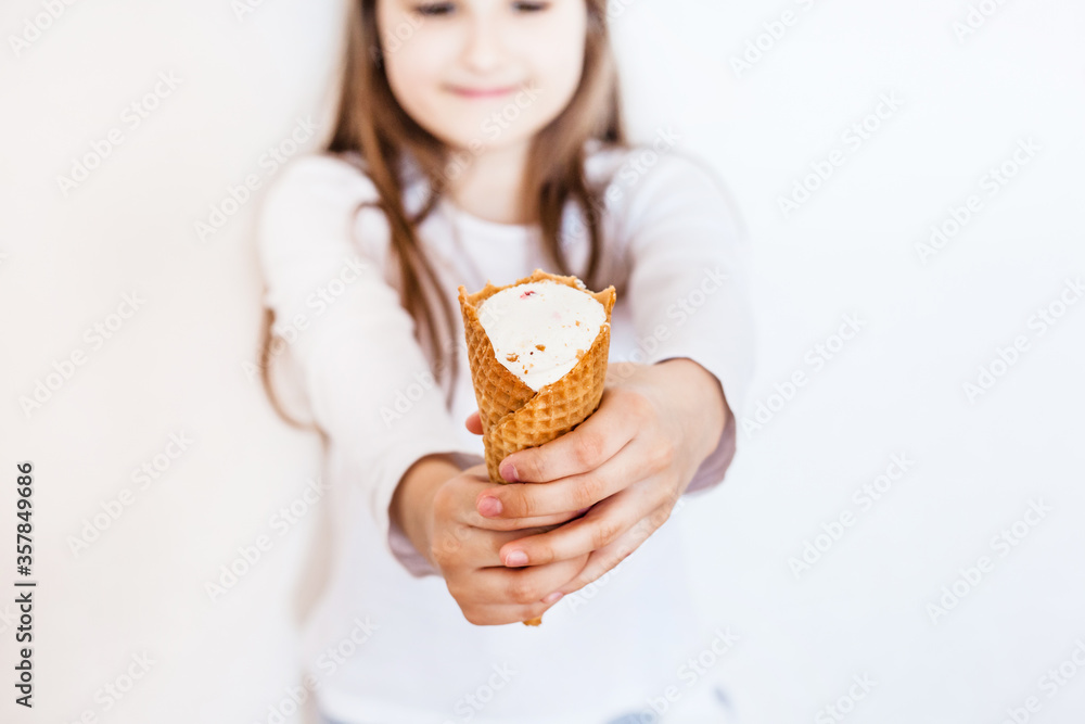 The girl holds in her hand ice cream, white background, isolate, delicious sweetness, treat The girl holds in her hand ice cream, white background, isolate, delicious sweetness, treat