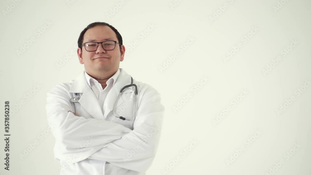 Happy Asian doctor folded arms isolated on white background.Concept of profession, medicine and healthcare, medical education.Male therapist folds his arms in front of himself, standing in a rehab Happy Asian doctor folded arms isolated on white background.Concept of profession, medicine and healthcare, medical education.Male therapist folds his arms in front of himself, standing in a rehab