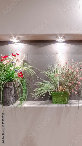 Fototapeta Naklejka Na Ścianę i Meble -  Vertical Three flower arrangements in a wall alcove