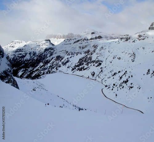 Beautiful winter view of Alpine mountains with Fedaia lake. Sella Ronda. Marmolada. Dolomites. South Tirol. Trentino-Alto Adige. Italy.