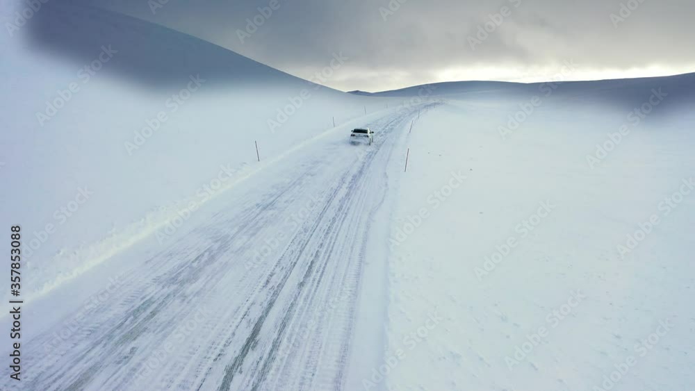 Snowy desert. Road in the snow in Norway. Winter in Norway. Vodiettle on a snowy road. Driving a car in winter. Aerial view from a bird's flight. Panoramic view of the snowy desert. Snowy desert. Road in the snow in Norway. Winter in Norway. Vodiettle on a snowy road. Driving a car in winter. Aerial view from a bird's flight. Panoramic view of the snowy desert.