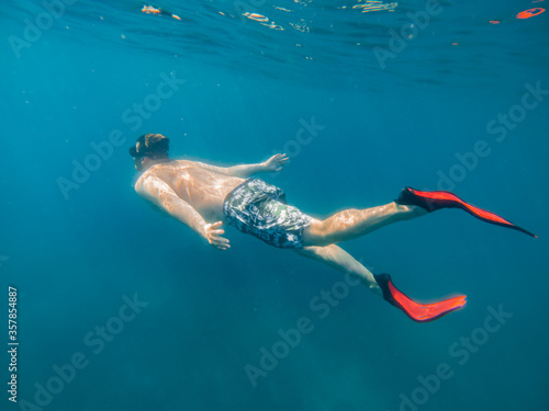 man in underwater in flippers looking at sea bottom © phpetrunina14