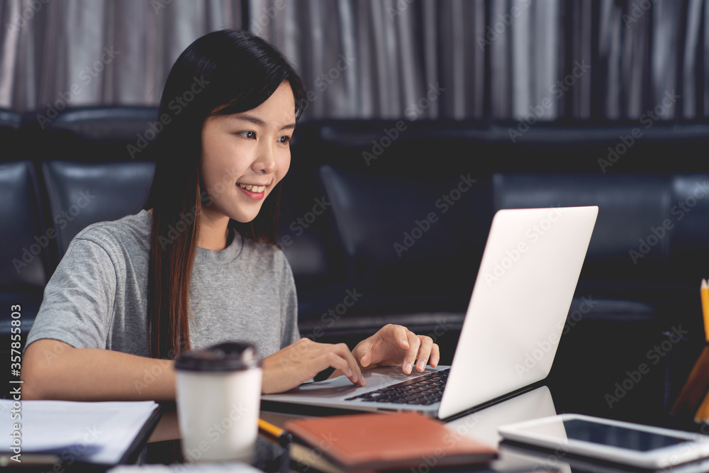 Attractive asian woman working with laptop and document Attractive asian woman working with laptop and document