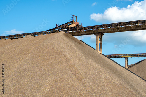 Vintage retro effect filtered hipster style image of an industrial background - crusher (stone crushing machine) in an open pit mining and processing plant for crushed stone, sand and gravel.