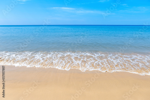 Blue sea and clean sand beach with clear blue sky, summer outdoor day light, relaxing by the beach, paradise island in South of Thailand