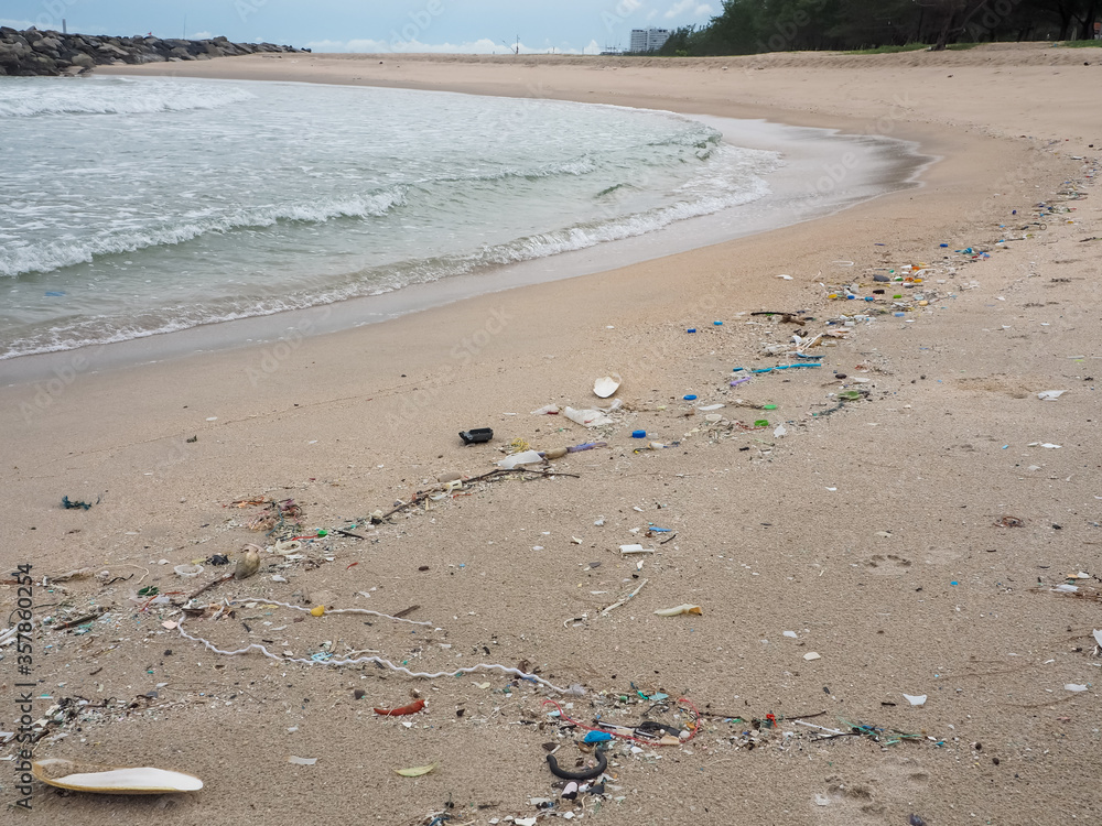Beach pollution. Plastic bottles and other trash on sea beach. Ecological concept Not beautiful