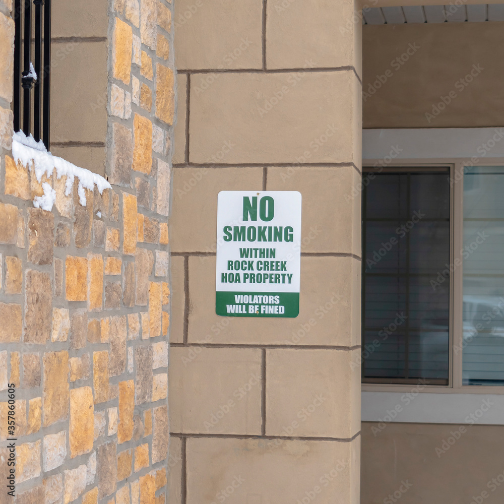 Square Exterior view of apartments with No Smoking sign on the stone