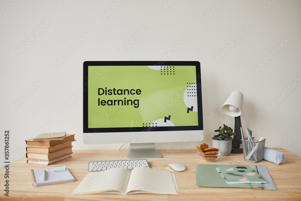Background image of minimal workplace setting with computer on desk and digital learning website on screen, copy space Background image of minimal workplace setting with computer on desk and digital learning website on screen, copy space