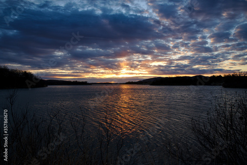 The sun sets over a lake in Oklahoma