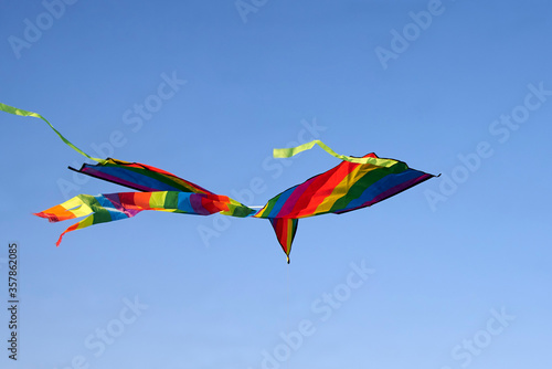 Bright multi-colored kite flying in the sky.