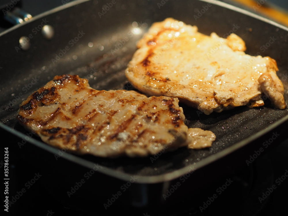 Pork Steak with Black Pepper and Pork sausage grilled on black pan food cooked for eat