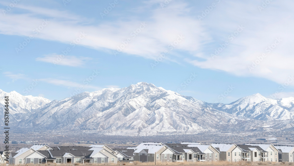 Panorama frame Striking Wasatch Mountains and South Jordan City in Utah during winter season