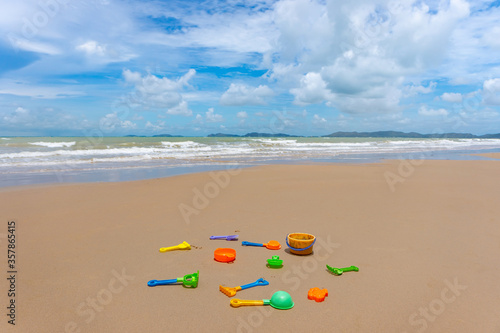 Colorful sand toy on the white sand beach at summer time.