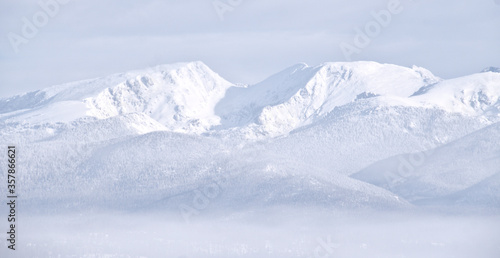 Snow covered white mountains in Colorado with fog