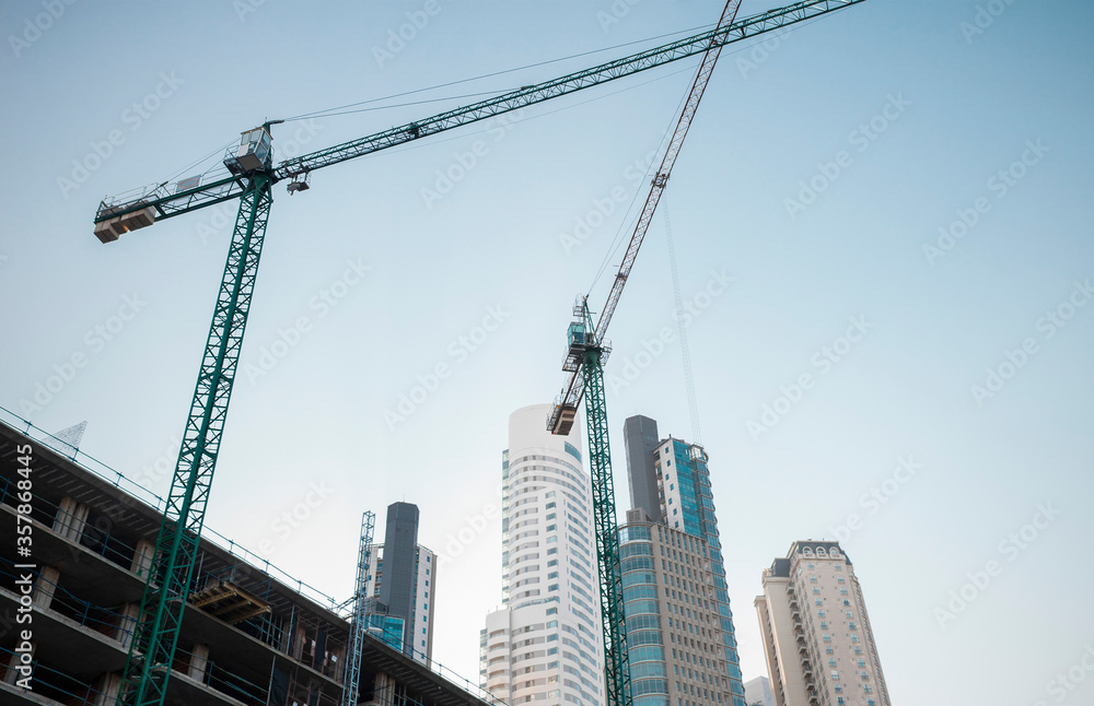 
Construction of building with cranes